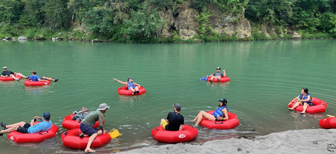 Group enjoying water adventures with inflatable rafts, kayaks, paddleboards, and float tubes in Portland, Oregon.