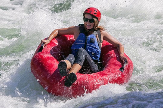 a person riding a wave on a surf board on a body of water